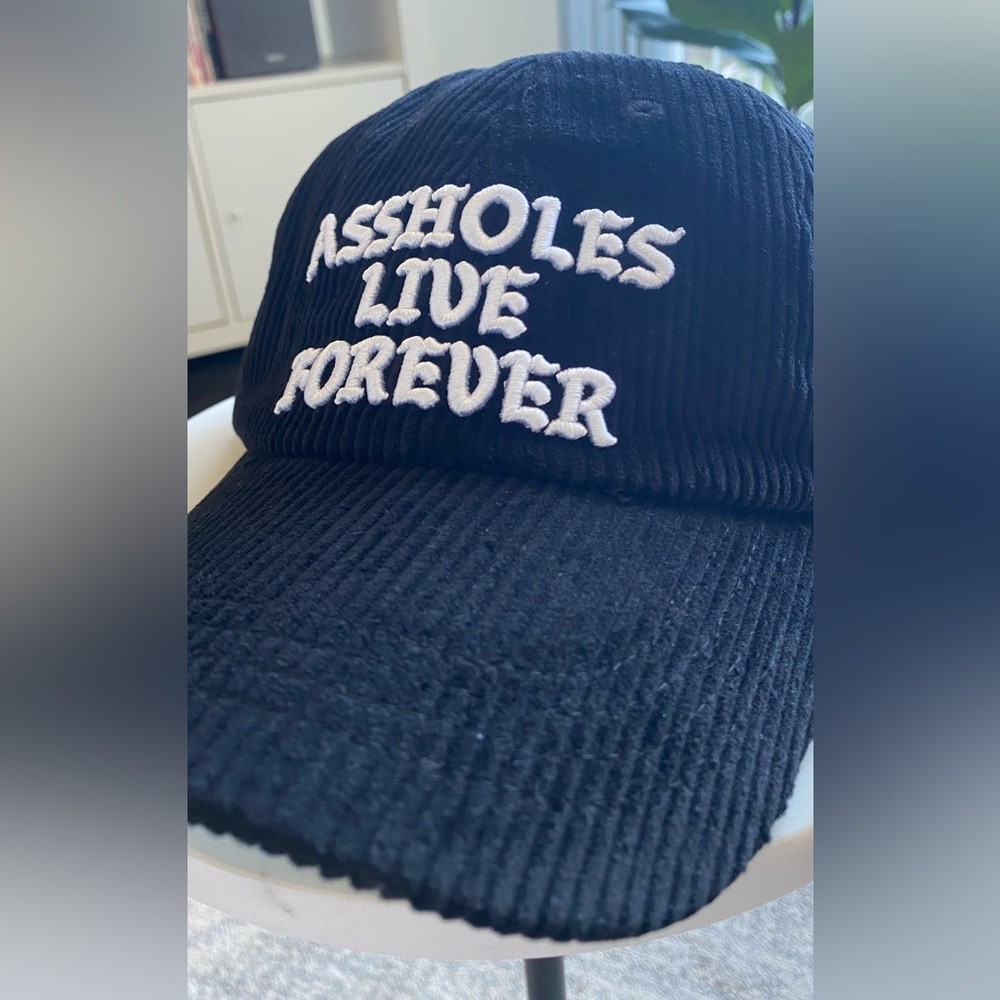 Black corduroy hat, Assholes Live Forever, adjustable w/ gold metal latch